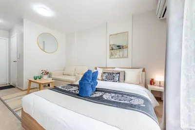 a bedroom with a bed with blue towels on it at Elio Sukhumvit 64 in Bangkok