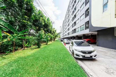 a white car parked on the side of a street at Elio Sukhumvit 64 in Bangkok