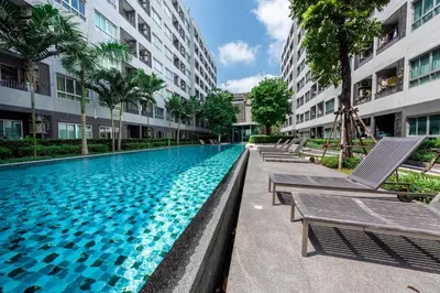 a swimming pool in the middle of a building at Elio Sukhumvit 64 in Bangkok