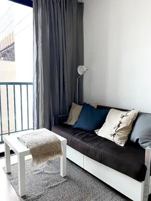 a couch in a living room with a window at Appartment ASTRO Condo 30 days minimum in Pak Kret