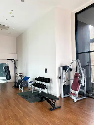 a room with a gym with a treadmill and weights at Appartment ASTRO Condo 30 days minimum in Pak Kret