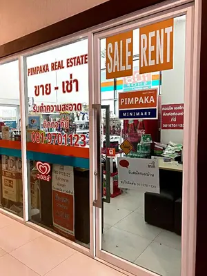 a store with signs on the windows of a store at Appartment ASTRO Condo 30 days minimum in Pak Kret