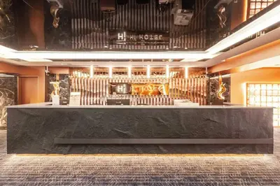 a bar in a building with a bar counter at Palette Hi Hotel Bangkok in Makkasan