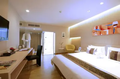 a hotel room with a large bed and a desk at Palette Hi Hotel Bangkok in Makkasan