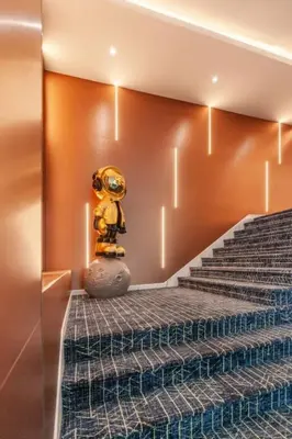 a robot sitting next to a set of stairs at Palette Hi Hotel Bangkok in Makkasan