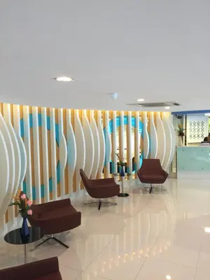 a waiting room with chairs and a wall at Grand Tower Inn Sathorn Hotel in Bangkok