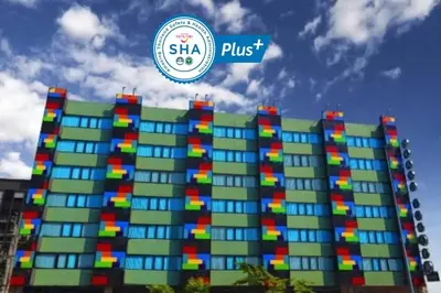 a large building with colorful windows and a logo at Grand Tower Inn Sathorn Hotel in Bangkok