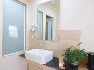 a bathroom with a sink and a mirror at Studio 36 in Bangkok