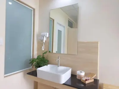 a bathroom with a sink and a mirror at Studio 36 in Bangkok