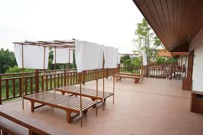 a balcony with two benches and nets on it at Thaihome Resort in Ban Bang Muang
