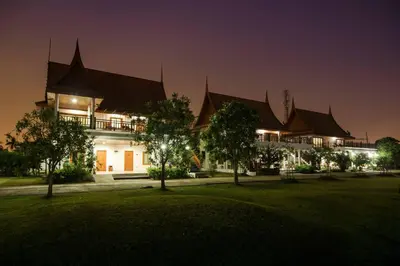 a large building at night with its lights on at Thaihome Resort in Ban Bang Muang