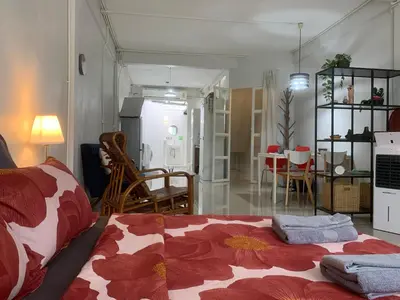 a living room with a bed and a dining room at COSY 4th floor with rooftop in Bangkok