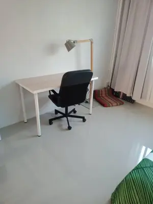 a desk with a black chair and a lamp at COSY 4th floor with rooftop in Bangkok