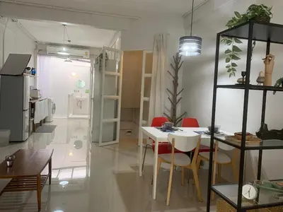 a dining room with a white table and chairs at COSY 4th floor with rooftop in Bangkok