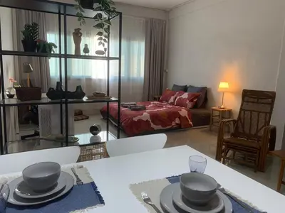 a living room with a table with hats on it at COSY 4th floor with rooftop in Bangkok