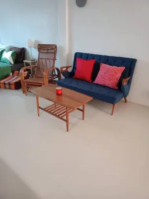 a living room with a blue couch and a coffee table at COSY 4th floor with rooftop in Bangkok