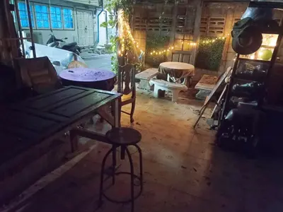 a room with a wooden table and chairs and lights at NP Prime FREE WiFi in Bangkok