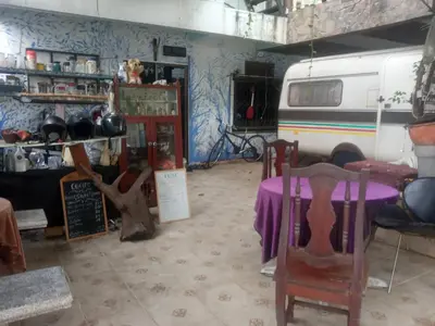 a room with a table and chairs and a van at NP Prime FREE WiFi in Bangkok