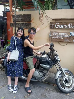 a man and a woman sitting on a motorcycle at NP Prime FREE WiFi in Bangkok