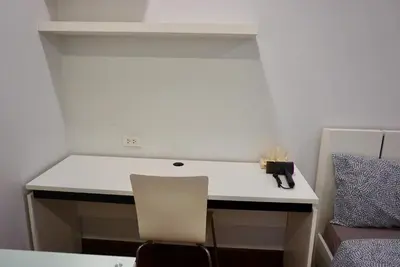 a room with a white desk with a chair at Sathon 15 apartment close to BTS Skytrain St Louis & Surasak in Bangkok