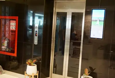 a glass elevator in a building with a window at Sathon 15 apartment close to BTS Skytrain St Louis & Surasak in Bangkok