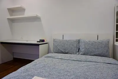 a bedroom with a bed with blue sheets and pillows at Sathon 15 apartment close to BTS Skytrain St Louis & Surasak in Bangkok