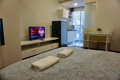 a bedroom with a bed with two pillows on it at Hip & Funky Sathon15 apartment close to BTS St Louis in Bangkok