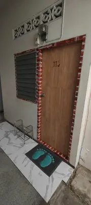 a door in a room with a mat in front of it at 113 Cozy Loft style with cool fan with free Wi-fi in Bangkok