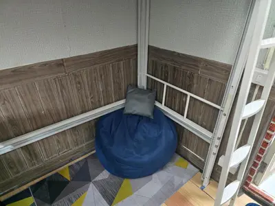 a room with a blue bean bag chair in the corner at 113 Cozy Loft style with cool fan with free Wi-fi in Bangkok