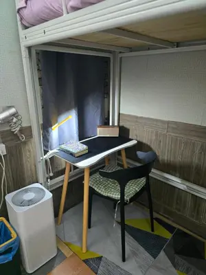 a room with a desk and a bed and a chair at 113 Cozy Loft style with cool fan with free Wi-fi in Bangkok