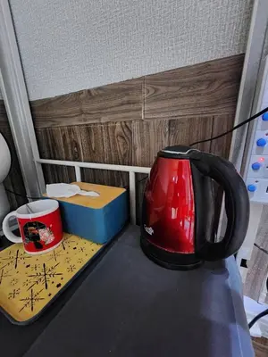 a red tea kettle and a box on a counter at 113 Cozy Loft style with cool fan with free Wi-fi in Bangkok
