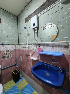 a bathroom with a sink and a climbing wall at 113 Cozy Loft style with cool fan with free Wi-fi in Bangkok