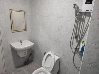 a bathroom with a shower and a toilet and a sink at Phenn's House @Ramkhamhaeng in Bang Kapi
