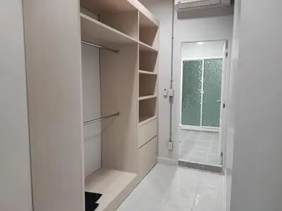 a white walk in closet with a glass door at Phenn's House @Ramkhamhaeng in Bang Kapi