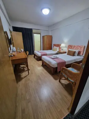 a hotel room with a bed and a couch and a table at 12PM Bangkok in Bang Kapi