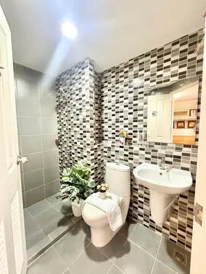 a bathroom with a toilet and a sink at เช่ารายเดือน DCon Rattanathibet in Ban Sai Ma