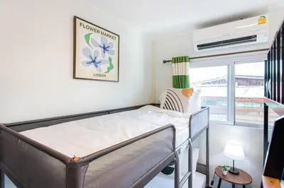 a hospital bed in a room with a window at Friend House BKK in Bangkok
