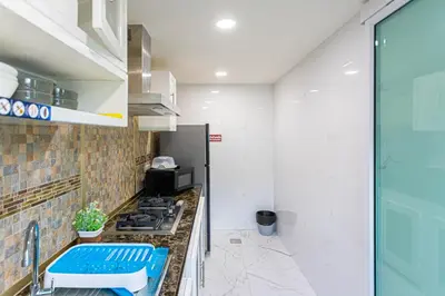 a kitchen with a stove and a counter top at Friend House BKK in Bangkok