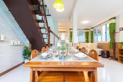 a dining room with a table and chairs at Friend House BKK in Bangkok