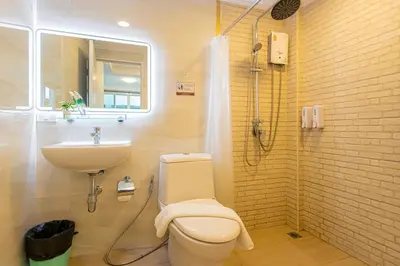 a bathroom with a toilet and a sink at Friend House BKK in Bangkok