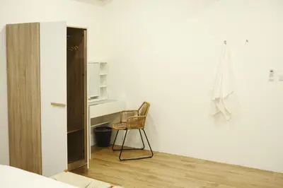 a room with a chair and a desk and a cabinet at 2BR Stylist Rare Find China Town in Bangkok