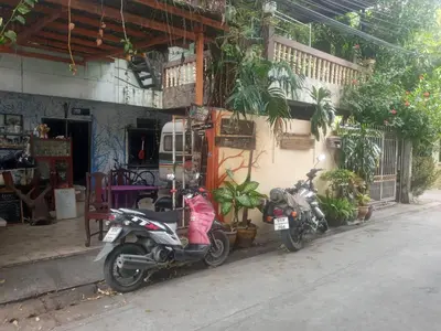 two motorcycles parked in front of a building at Best Place Have Air Conditioner in Bangkok
