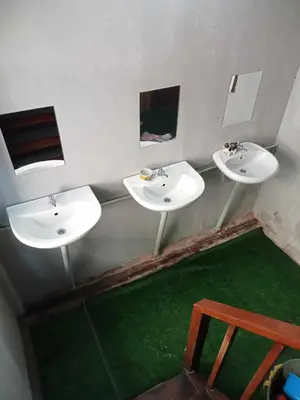 two sinks in a bathroom with a green floor at Bang lumphu house&bistro in Bangkok