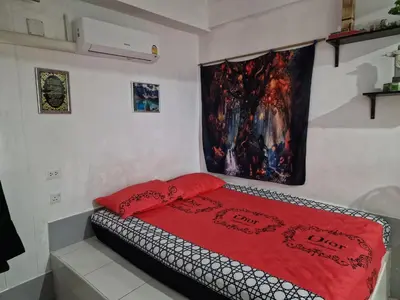 a bedroom with a bed with a red blanket at BTL Sunny in Bang O