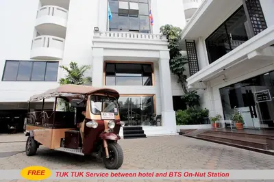 a tuk service vehicle parked in front of a building at Chateau de Sukhumvit in Bangkok