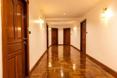 an empty hallway with wooden floors and doors at Rooftop Paradise & Koi Pond-6BR Hideaway@Icon Siam in Bangkok