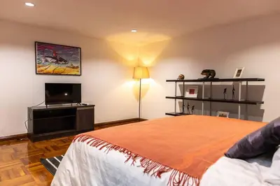 a bedroom with a bed and a flat screen tv at Rooftop Paradise & Koi Pond-6BR Hideaway@Icon Siam in Bangkok