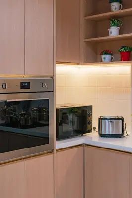 a kitchen with a stove and a toaster oven at PRIME SUKHUMVIT MODERN HOME, Phrom Phong BTS, Em District, Up to 14 guests in Bangkok