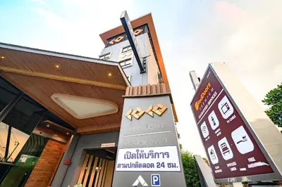 a building with a sign in front of it at Coco Hotel in Bangkok