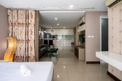 a hotel room with a bed and a kitchen at LIV@5 Condominium in Makkasan